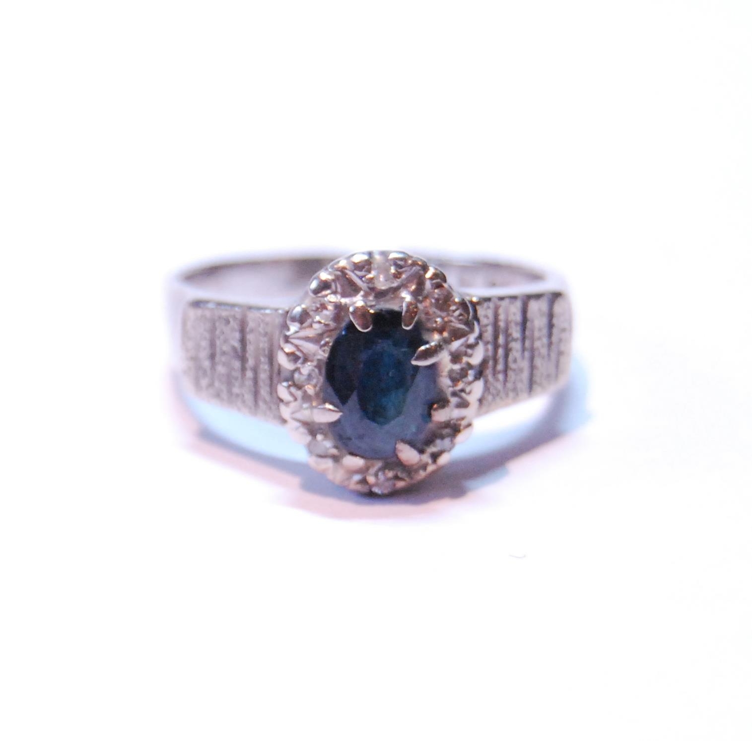 Diamond and sapphire oval cluster ring with eight-cut brilliants, in 18ct white gold, 1973, size