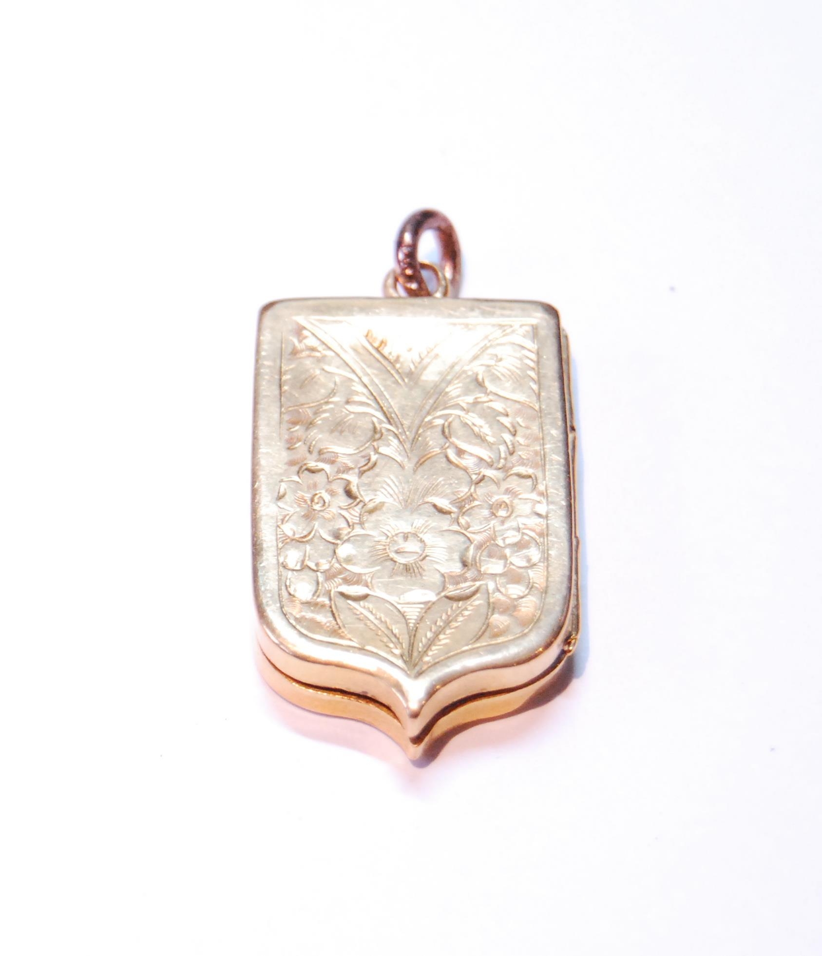 Victorian gold locket of shield shape, probably 18ct gold, 11g.