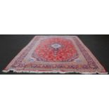 Persian Tabriz carpet with a large medallion to the centre, all over foliate swags to the border, on