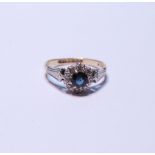 18ct gold sapphire and diamond cluster ring set with a sapphire to the centre surrounded by small