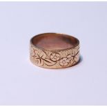 18ct gold band with all over foliate decoration, stamped '750', size N/O, 5.7g.