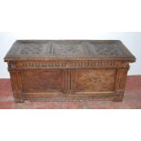 19th century carved oak coffer, the hinged top with three panels, with floral roundels, above