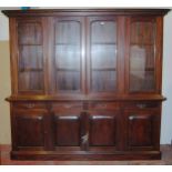 Victorian-style mahogany four-door library bookcase, the dentil decorated cornice above four