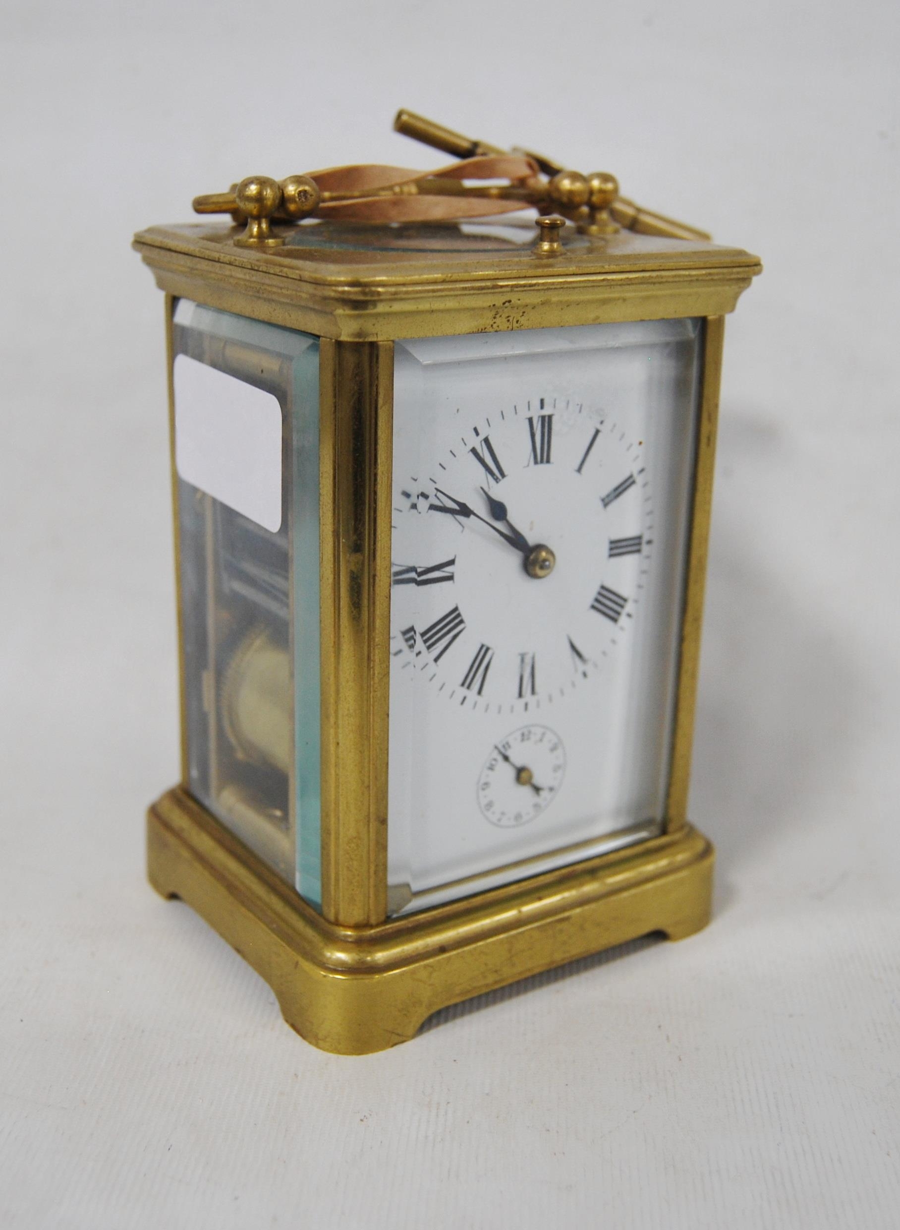 Brass repeater carriage clock with subsidiary seconds dial, with key, 12cm high.