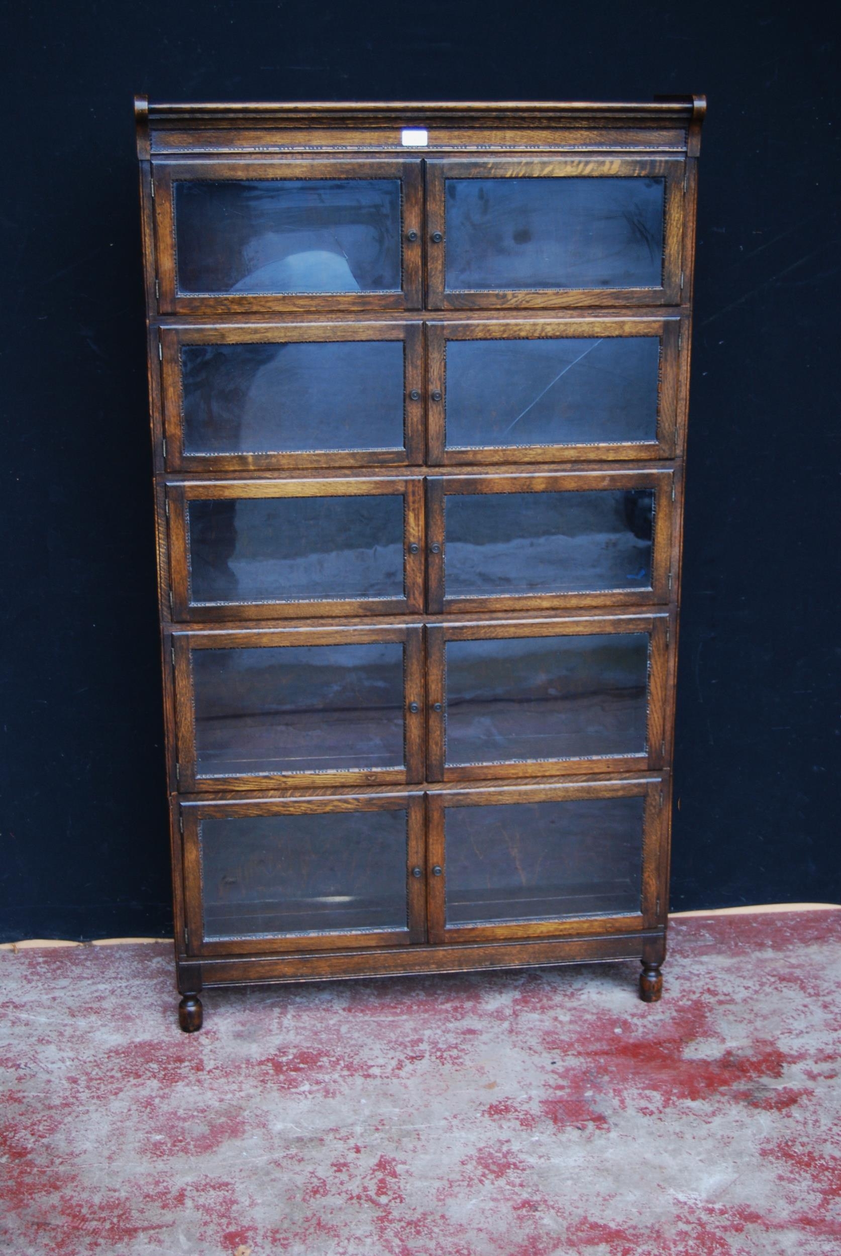 Oak bookcase with two glazed doors to each section, 161cm high, 89cm wide