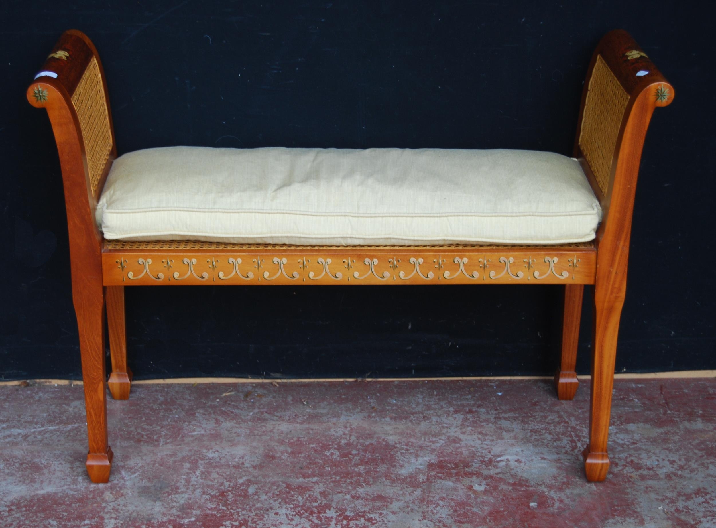 Bergère window seat in the Sheraton style with double cane sides and cushion to the seat, on tapered