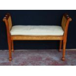 Bergère window seat in the Sheraton style with double cane sides and cushion to the seat, on tapered