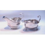 Silver sauce boat with cut edge on pad feet, and another, panelled oval, both by Adie Brothers,