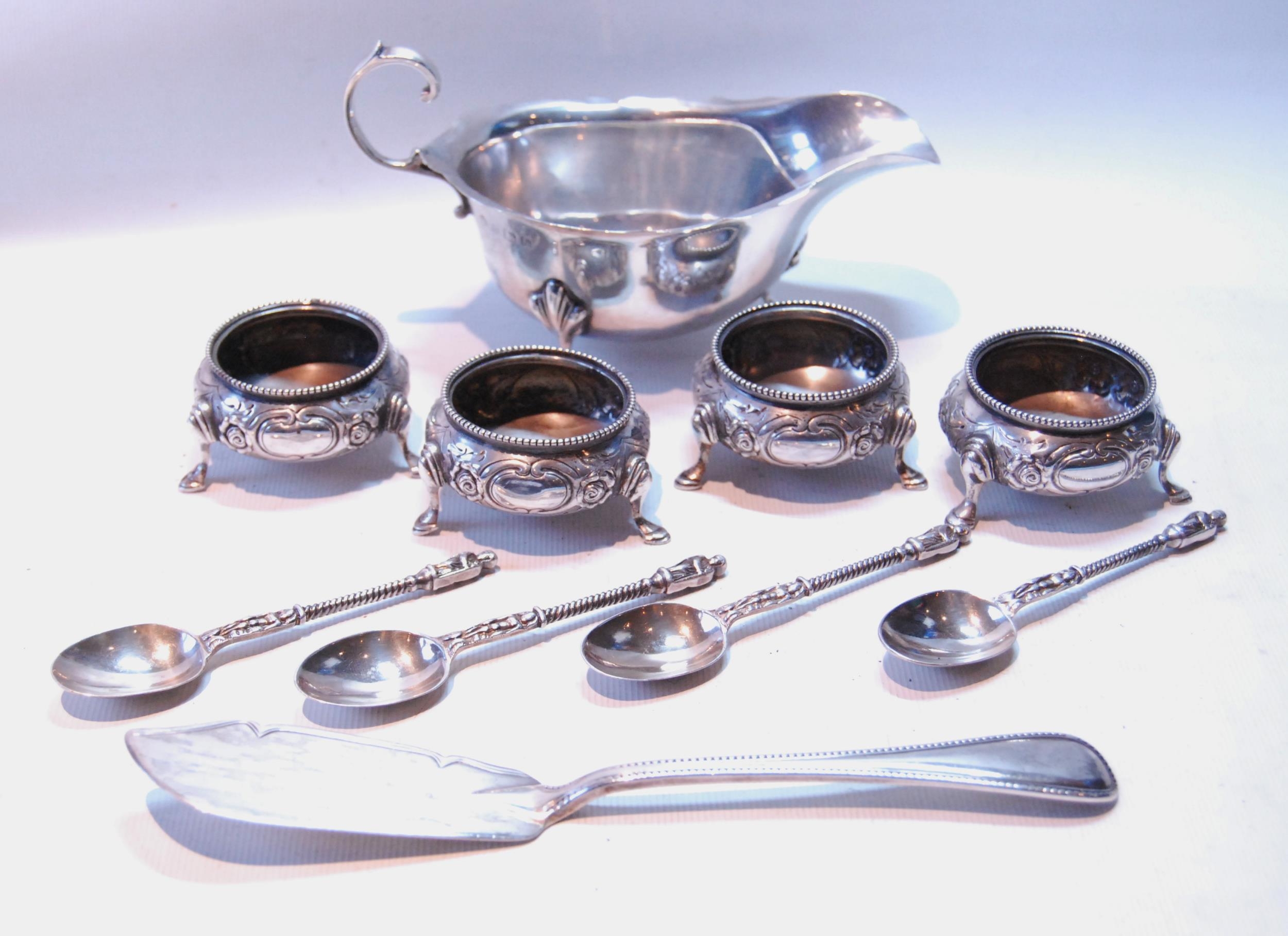 Silver sauce boat, four coffee spoons, a butter knife, 1881, and four embossed salts, 1882, 374g