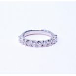 Diamond half eternity ring with eleven brilliants, each approximately .10ct, in platinum, size M.