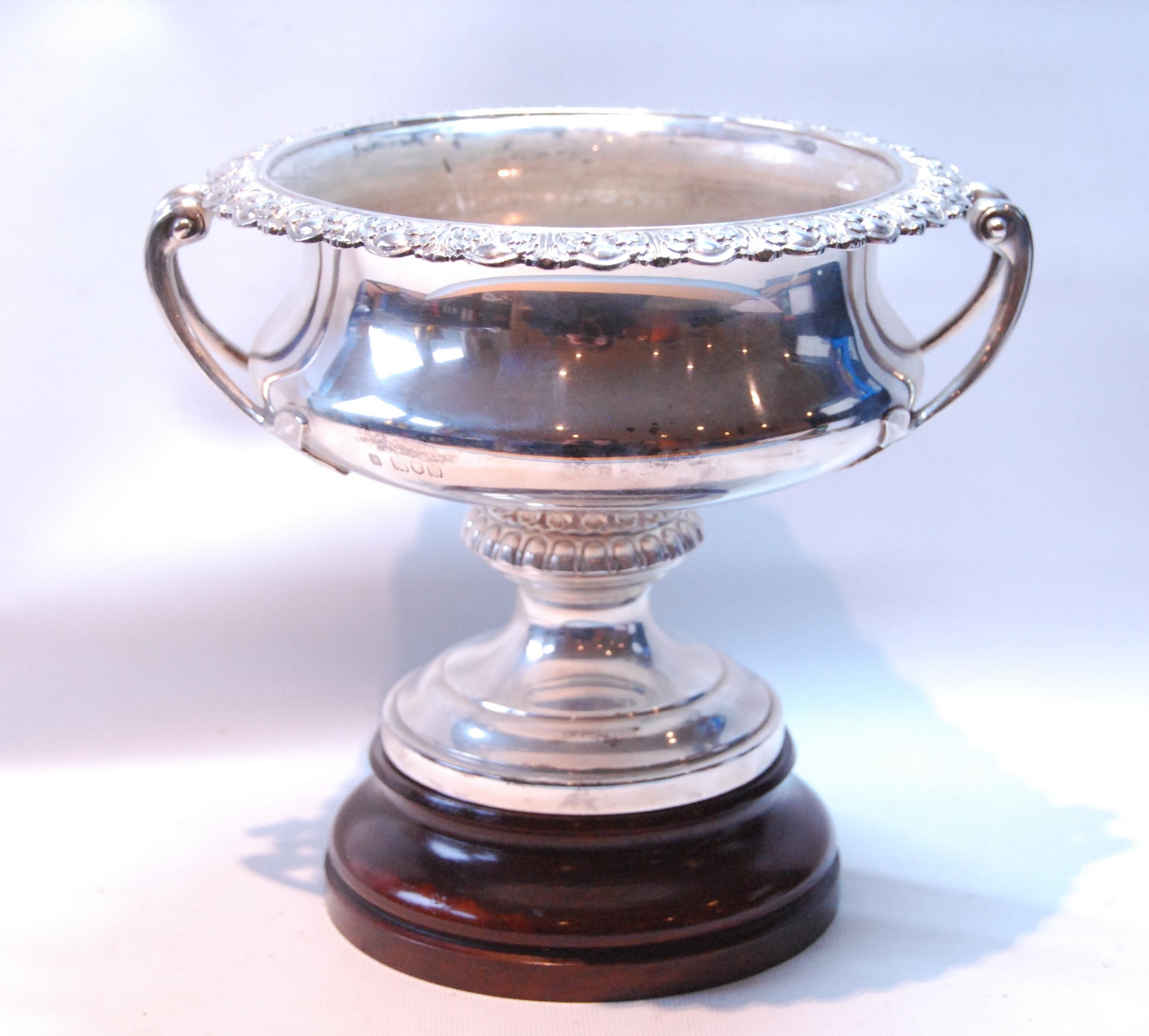 Silver circular bowl with gadrooned and foliate border and leafage bifurcated handles, on moulded