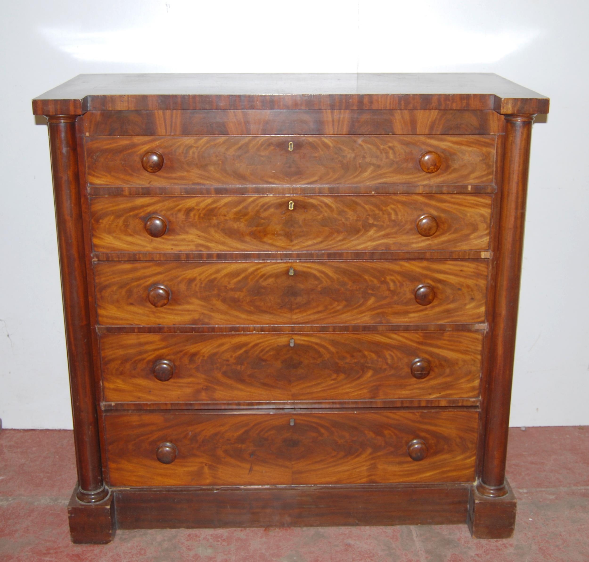 19th century mahogany chest of five long graduated drawers with turned handles, flanked by