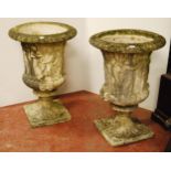 Two near-matching composition garden campagna urns of large form decorated with classical figures