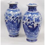 Pair of Delft-style blue and white vases in the Japanese taste, decorated with figures in foliage,