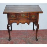 Georgian oak lowboy with three short drawers above a shaped apron, on cabriole legs with pad feet,