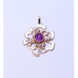 9ct gold openwork pendant with cabochon amethyst, 16.2g gross.