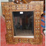 Antique Indo-Persian hardwood and marquetry inlaid wall mirror decorated all over with marquetry and