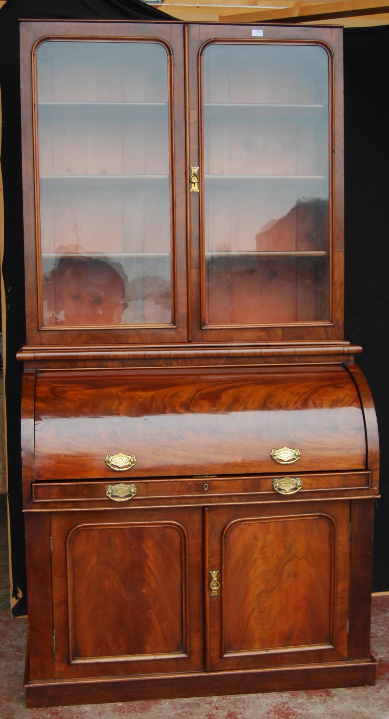 Victorian mahogany library bookcase on cylinder bureau base, the bookcase section with two glazed