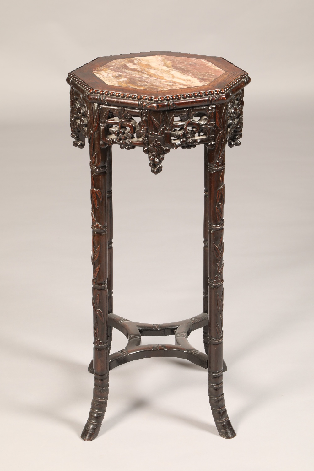 Cylinder carved hardwood Jardiniere stand, octagonal top with rouge marble inset, carved and pierced