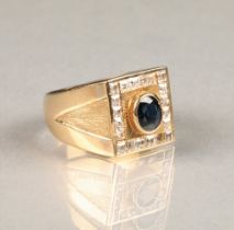 Gents 14 carat yellow gold dress ring, square faced with a central oval blue stone surrounded by a