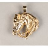 9 carat gold equestrian pendent in the form of a horse head, set with cubic zirconia's, weight 14g