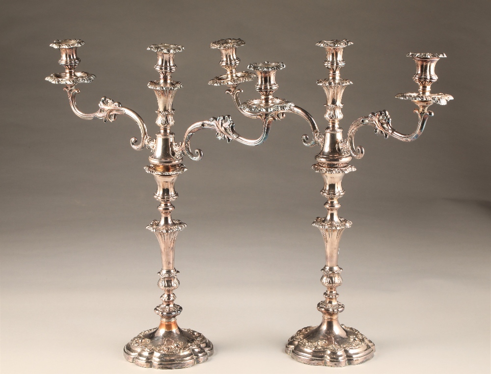 Pair large electro plated sliver three light candelabra, lobed circular based with foliate relief,