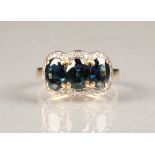 18 carat gold three stone sapphire ring, surrounded by diamonds. ring size M/N