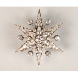 Victorian diamond encrusted star burst brooch, central diamond 0.75 carat, mounted on white metal