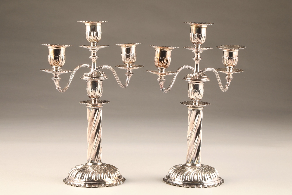 Pair electro plated silver three light candelabra, spiral twist circular base and columns, height