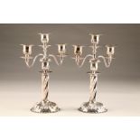 Pair electro plated silver three light candelabra, spiral twist circular base and columns, height