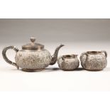 Three piece Chinese silver tea service comprising of teapot, sugar bowl & cream jug with embossed