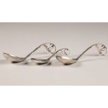 Boxed set of three Georg Jensen Silver serving spoons, with scrolled handles with leaf finials,