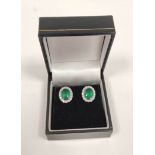 Pair of emerald and diamond cluster ear studs, in 18ct gold.