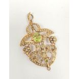 Victorian openwork pendant with oval peridot, scrolls and clusters of pearls, 9ct, 6.1g.