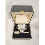Silver plain porringer with loop handles and a trefid spoon by Elkington, 1929, 212g, cased.  (2).