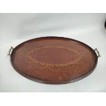 Mahogany oval serving tray with applied central satinwood laurel leaf and brass handles.