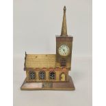 Apprentice brass and copper money box in the form of a church, with integral clock dial, coin