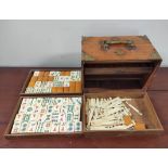 20th century Chinese Mah-Jong set, the bone tiled pieces contained in a five drawer teak cabinet