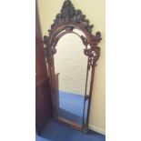 Mahogany fret wall mirror, with scrolled carved frame, the arched top with feather surmount, 189cm