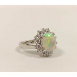 Diamond and opal oval cluster ring, in 18ct white gold, size 'H'.