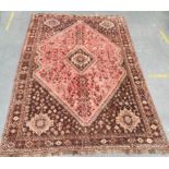 Mid-century Persian wool Shiraz rug, brown field interspersed with geometric motifs and central pink