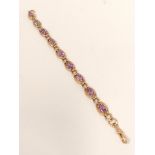 Gold curb bracelet with nine amethysts, 16.4g.