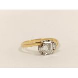 Diamond three stone baguette ring, the largest approximately 10mm x 5mm, flanked by two others, in