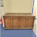 Antique oak coffer with five panel hinged top, above four panel front, 75cm x 140cm x 63cm.