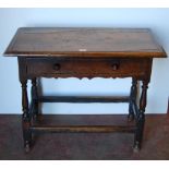 English Arts & Crafts  Oak writing table, the long drawer with ornate peg handles, on turned