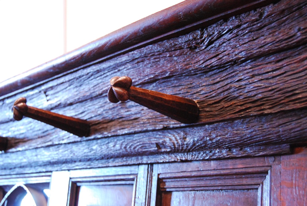 English Arts & Crafts  Oak hallstand with naturalistic cornice and five ornate pegs above a Gothic- - Image 3 of 5