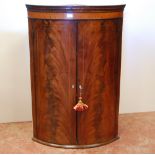 George III inlaid mahogany corner cupboard, c. late 18th/early 19th century, with two doors