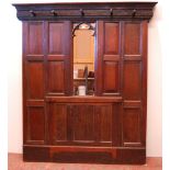 English Arts & Crafts  Oak hallstand with naturalistic cornice and five ornate pegs above a Gothic-