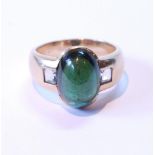 Tourmaline ring with oval cabochon (uncertificated) flanked by two aquamarines, in gold, '585', size