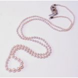 Necklace of graduated pearls on white gold snap with rose diamonds.